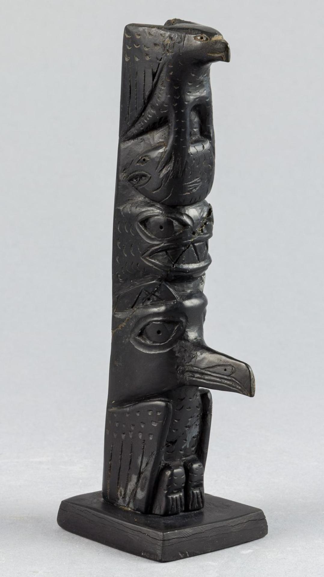 Moses Ingram - a carved argillite pole depicting Eagle holding Salmon
