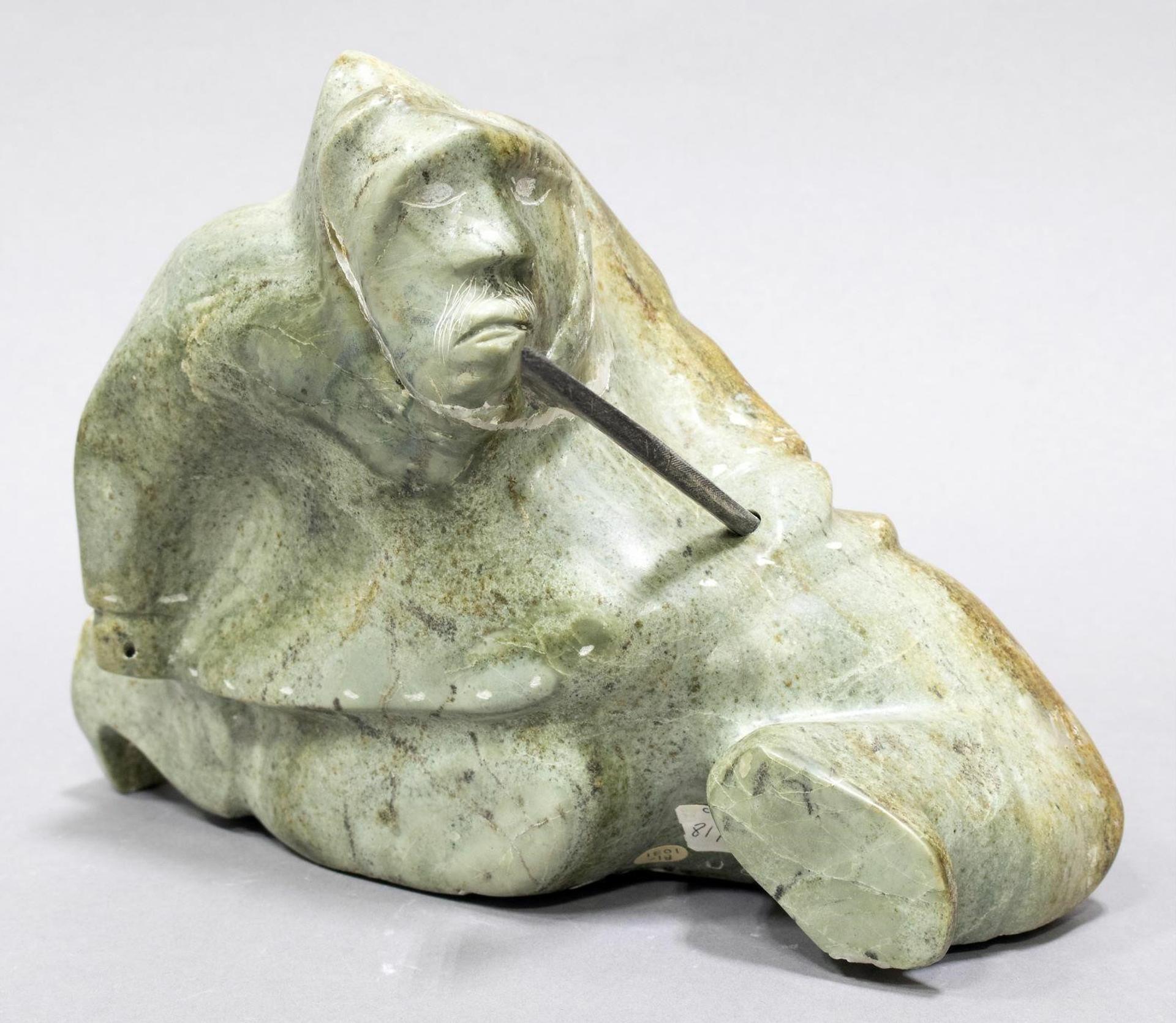 Davidee Kavik (1915) - a green-orange stone carving of a Fisherman with Spear (baleen)