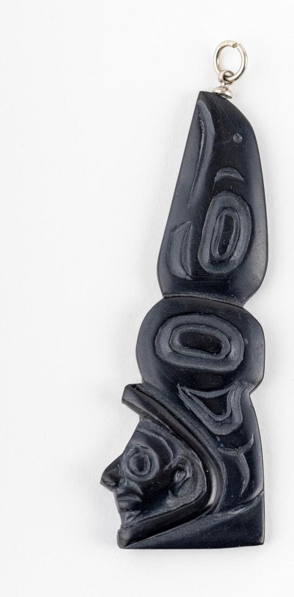 Greg White - a carved argillite pendant in the form of Raven and Man