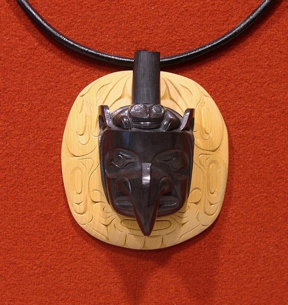 Donnie Edenshaw (1978) - a carved argillite and yellow ceder pendant on a leather necklace