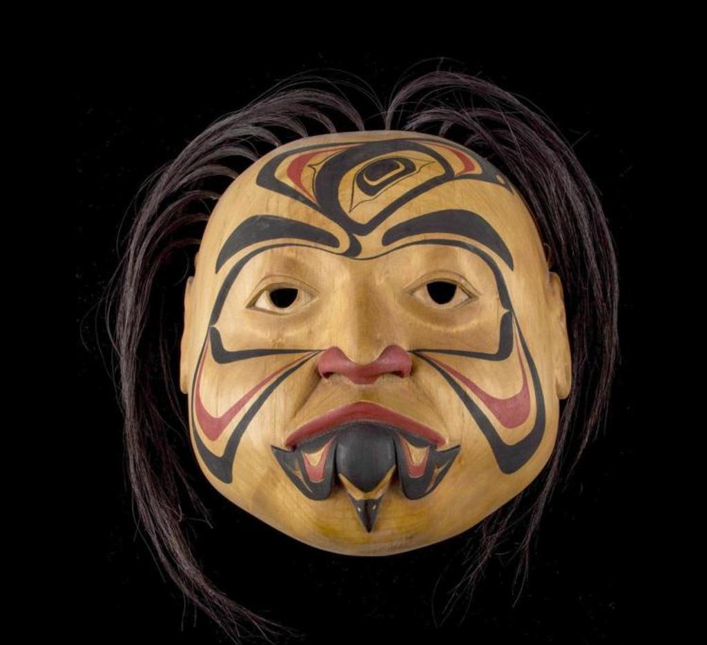 Glen Rabena (1953) - a carved and polychromed alder mask decorated with images of Raven and Hummingbird