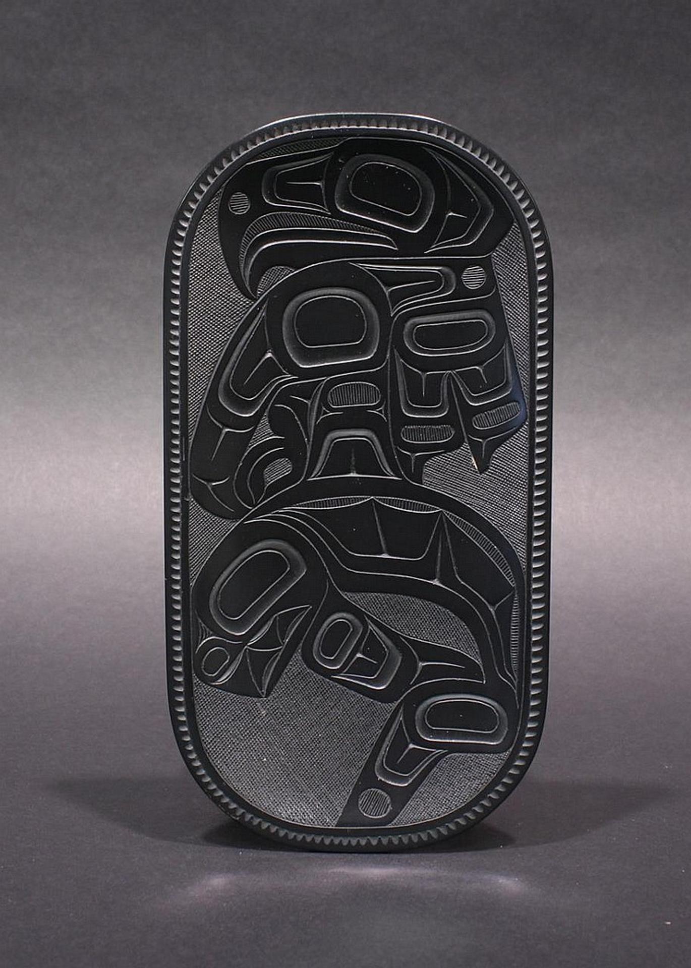 Pat Dixon (1938-2015) - an oval argillite plate decorated with Eagle and Killer whale design
