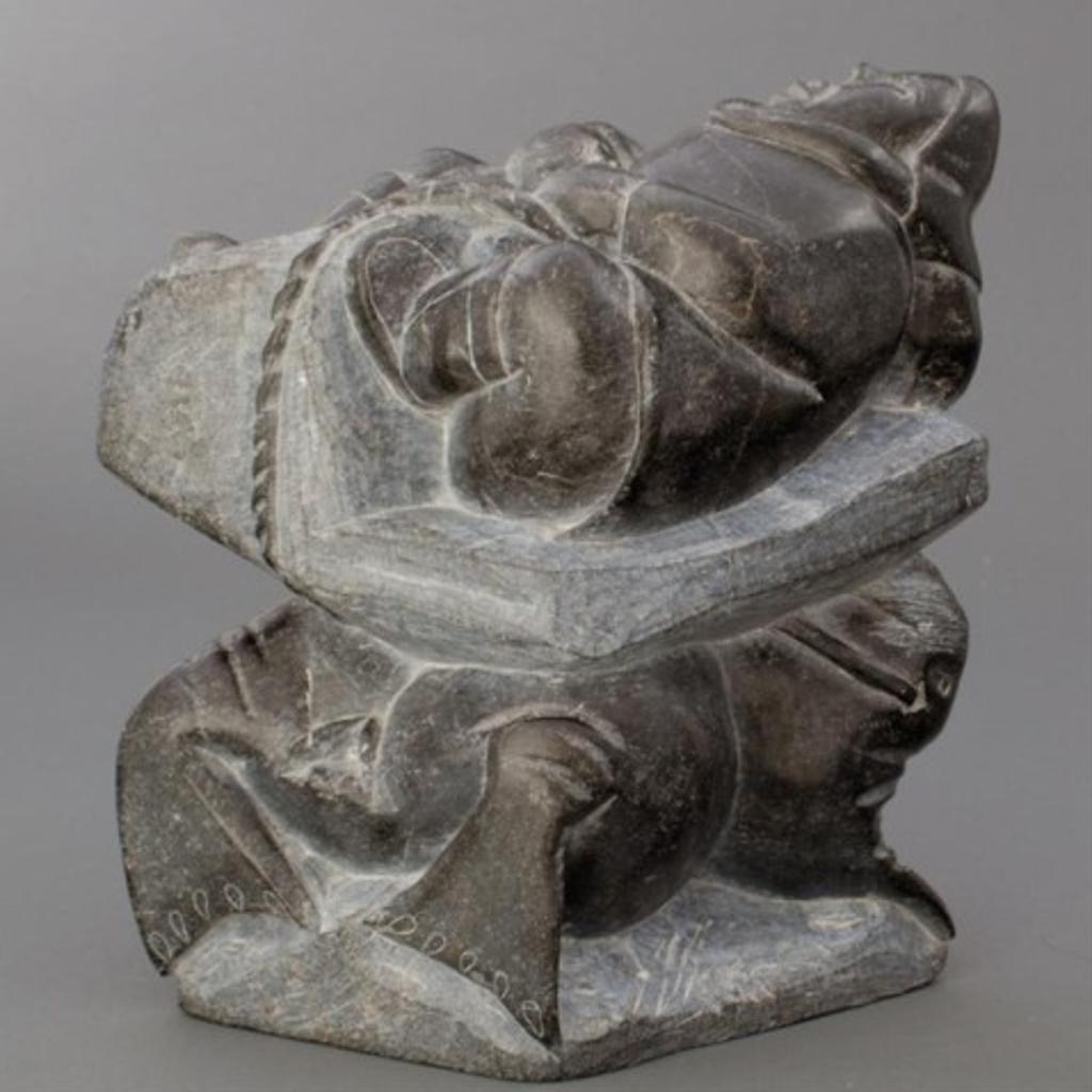 Aisa Amittu (1951) - Grey stone carving of a hunter attempting to pull walrus through the ice