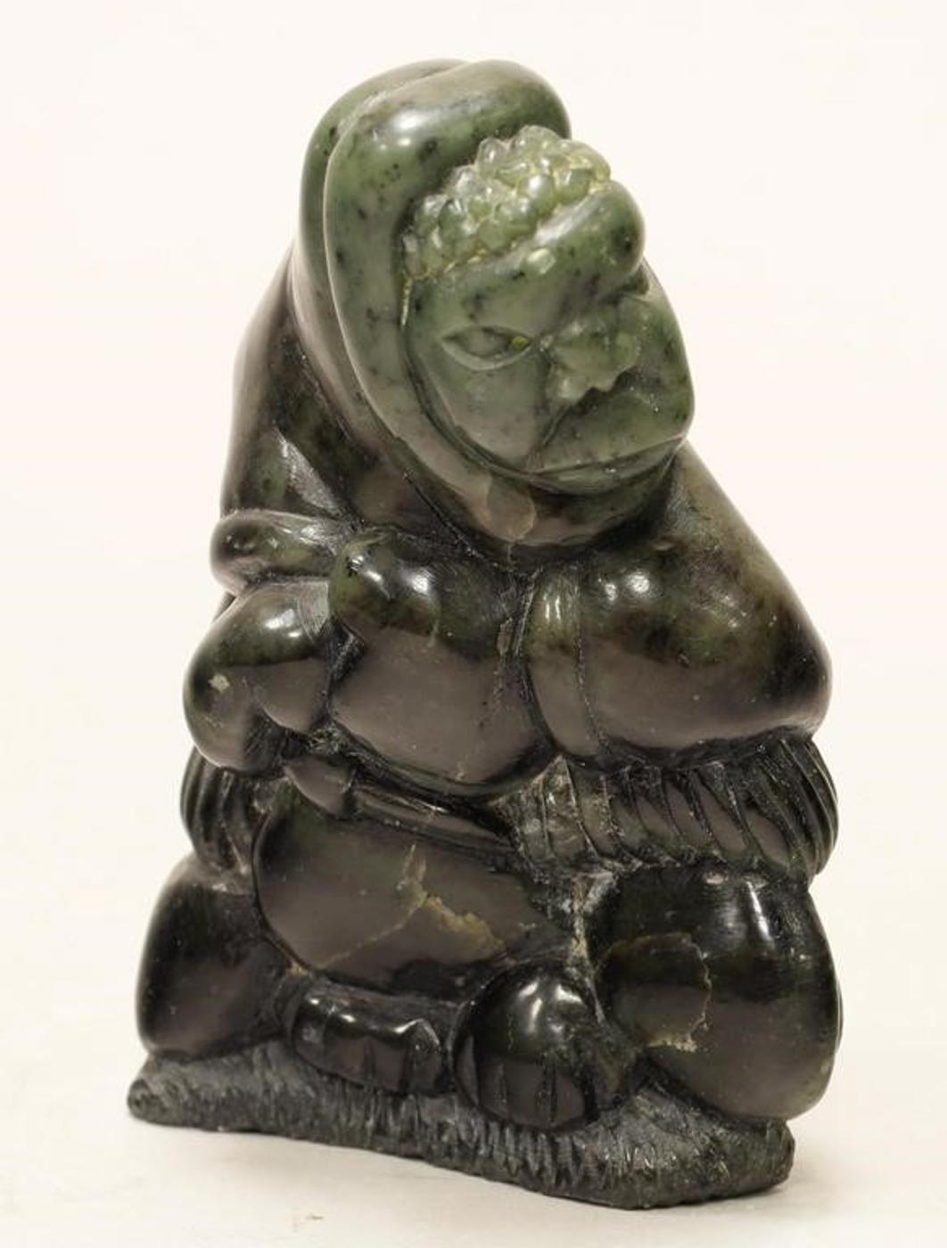 Charlie Inukpuk (1941) - A black-green stone carving of a Hunter