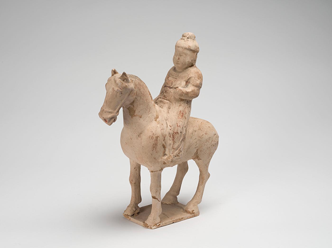 Chinese Art - A Chinese Buff Earthenware Model of an Equestrian Figure, Tang Dynasty (618-907 CE)