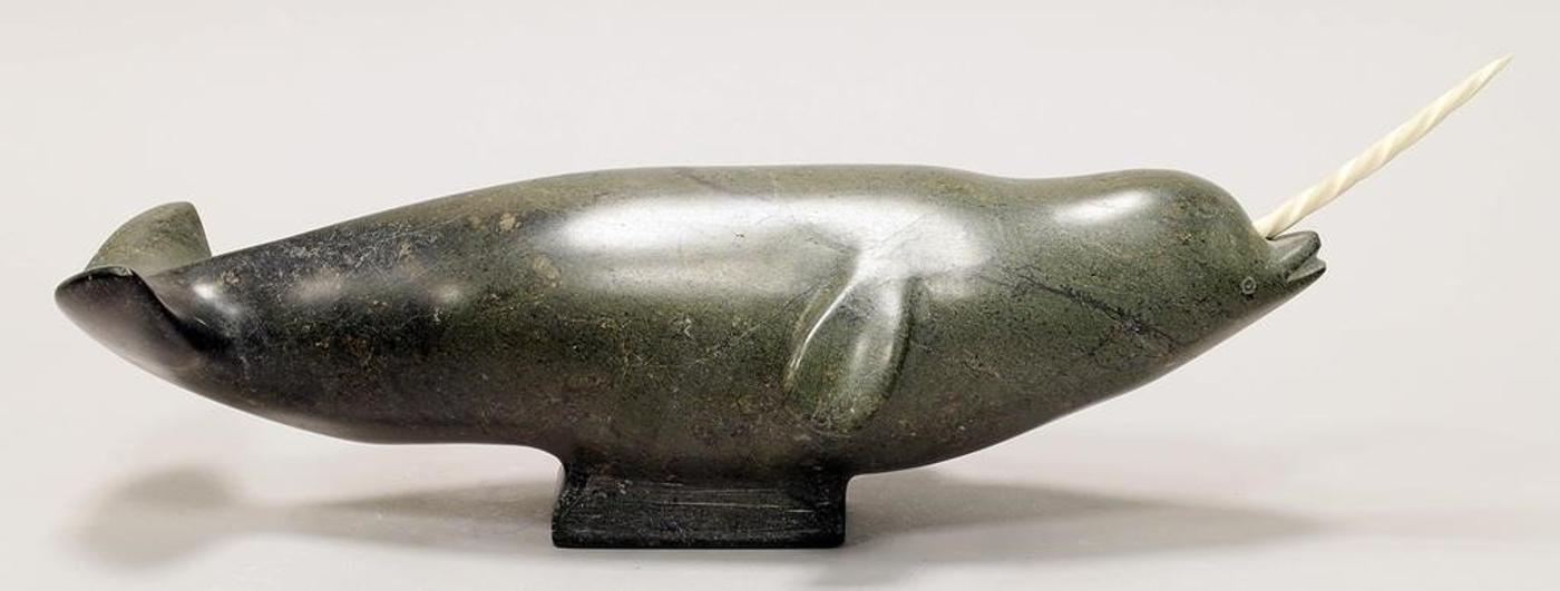 Itee Temela (1942) - A  mottled grey stone carving of a Narwhal with bone tusk