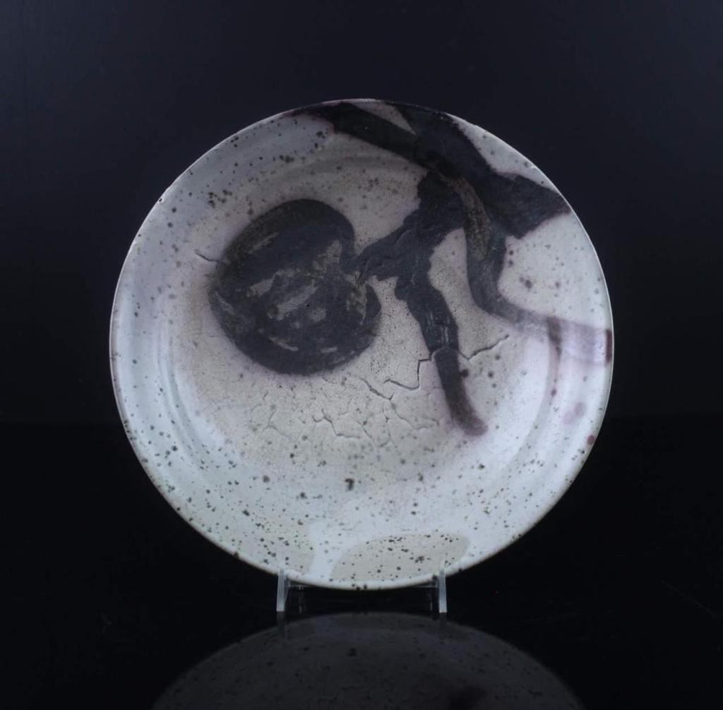Wayne G. Ngan (1937-2020) - a ceramic bowl having a tan coloured glaze with a brown design to the centre