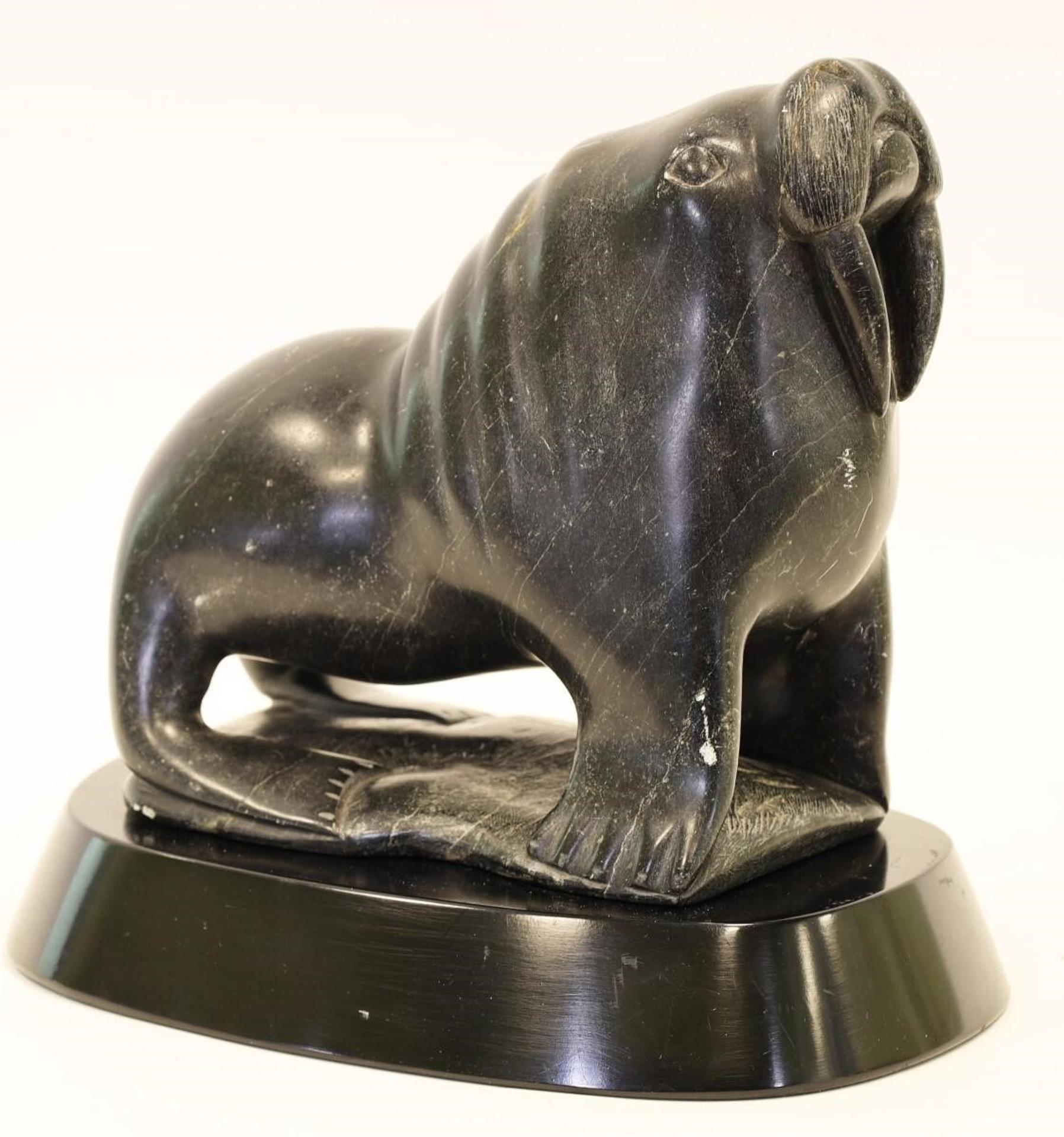 Eli Elijassiapik (1936) - a black variegated stone carving of a Walrus