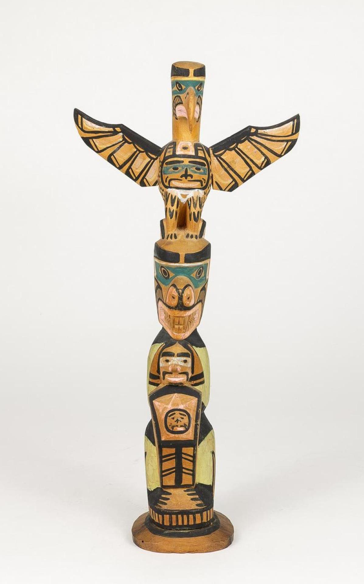 Charlie James (1865-1961) - a carved and polychromed totem pole depicting Thunderbird above Grizzly Bear holding Man and Copper