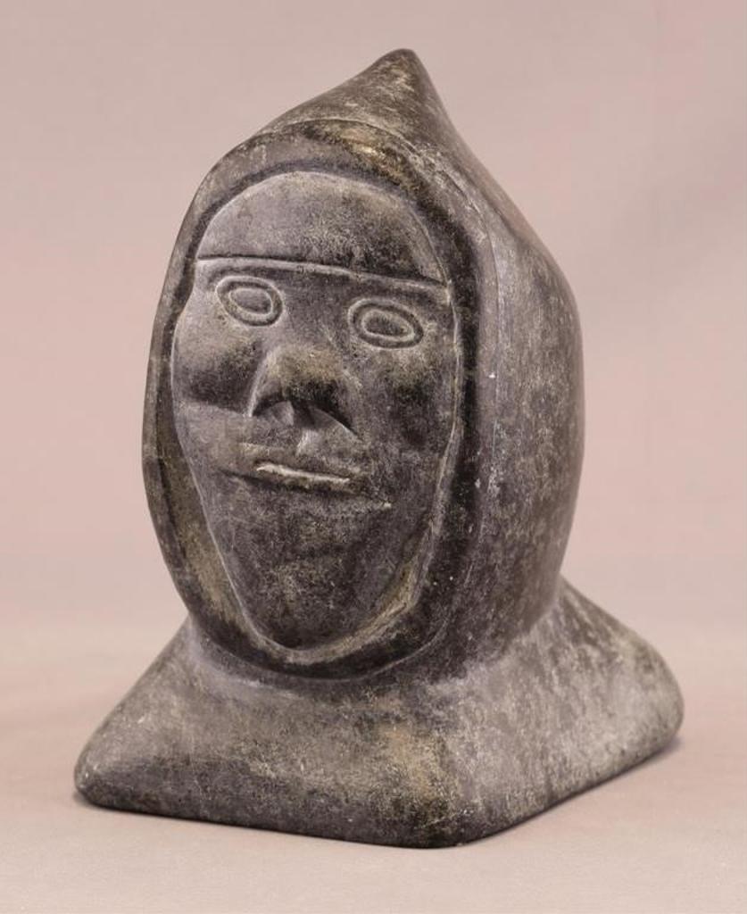 Samwillie Niviaxie (1923) - a mottled grey stone carving depicting an Inuk Head
