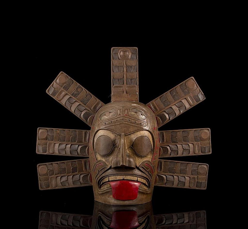 Norm John - a carved and stained cedar sun mask