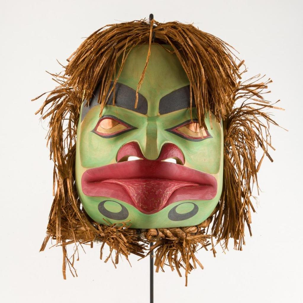 Ray Natraoro (1961) - a carved and polychromed Frog Woman mask having copper eyes