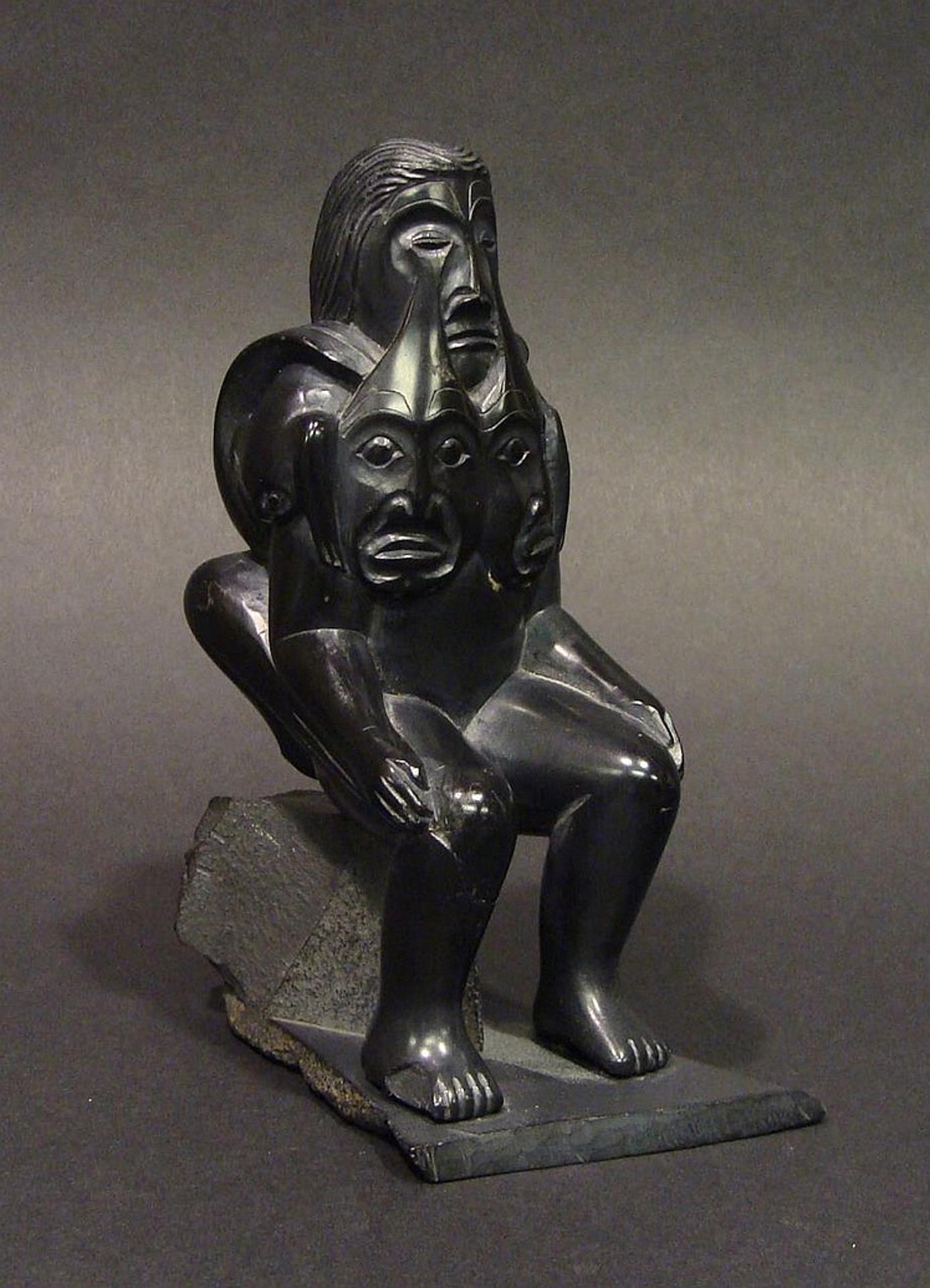 Jones Yeltatzie - an argillite carving of a weeping figure with frogs on his shoulders and back