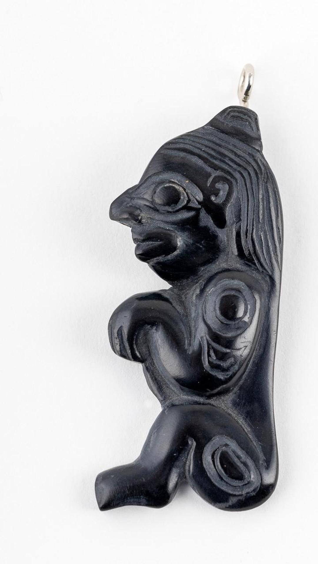 Gryn White - a carved argillite pendant of Bokwus