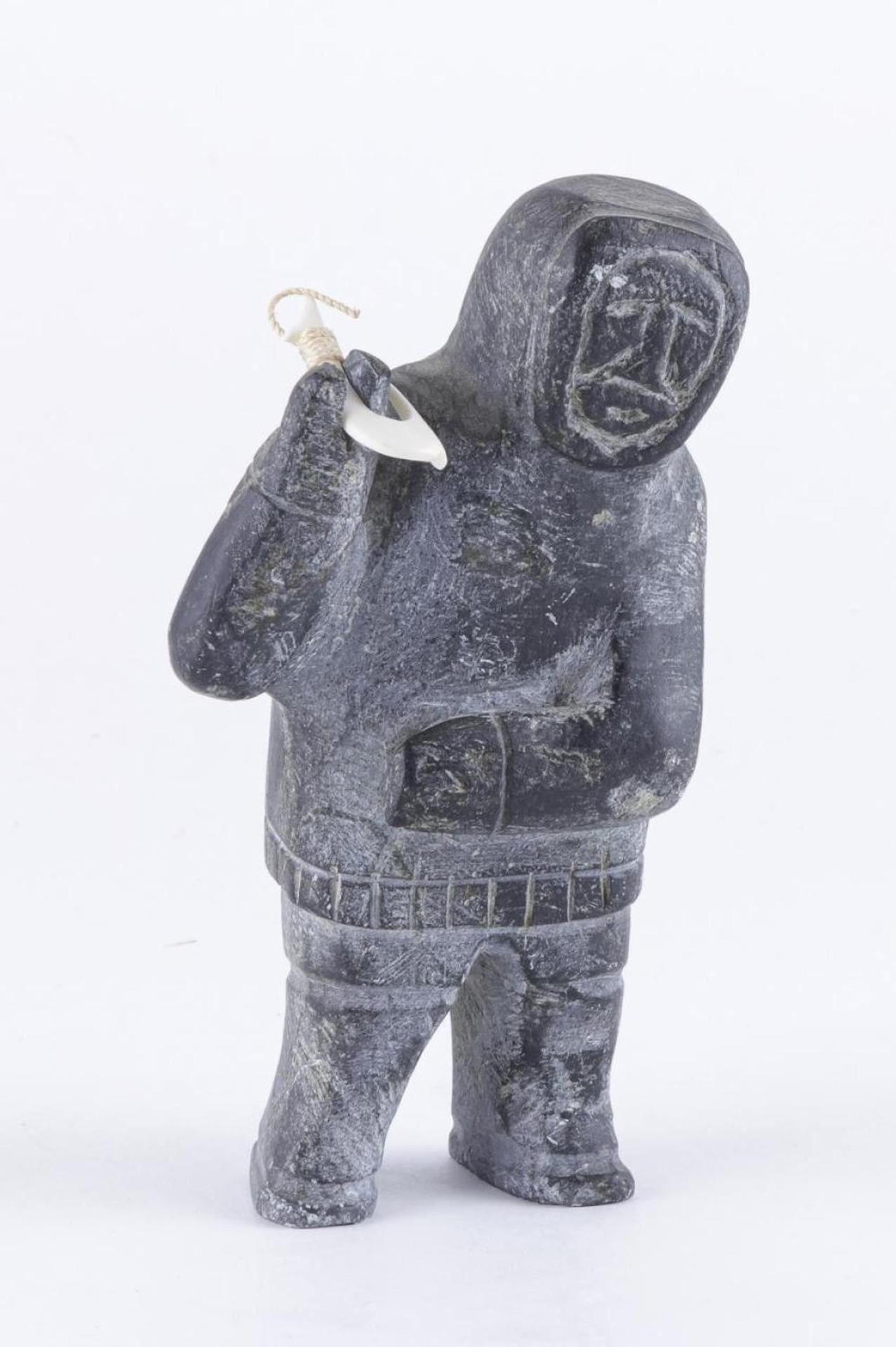 Jos - a black stone carving of a hunter