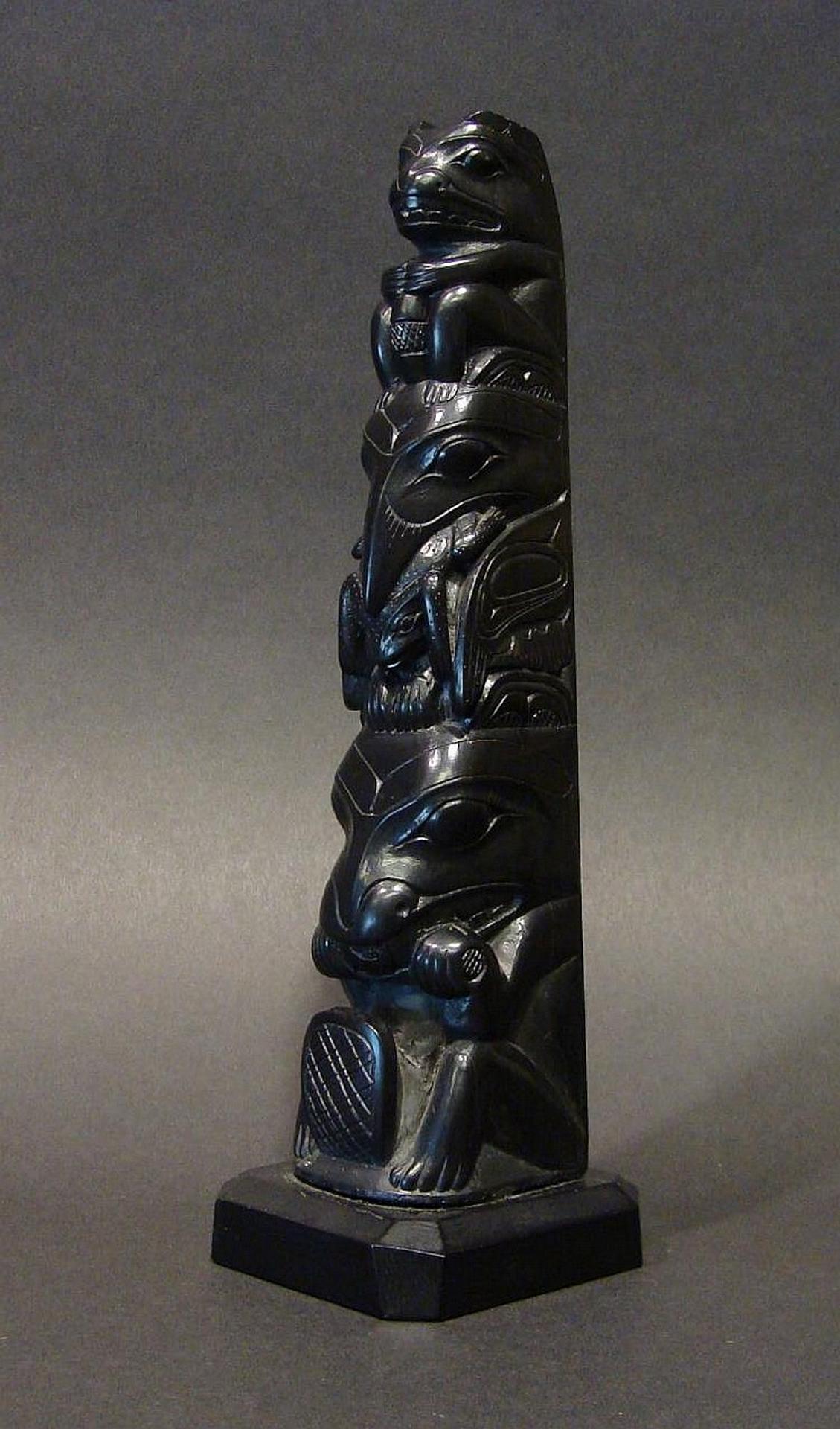 Louis Collinson (1881-1970) - a carved argillite 3 figure model pole depicting Bear