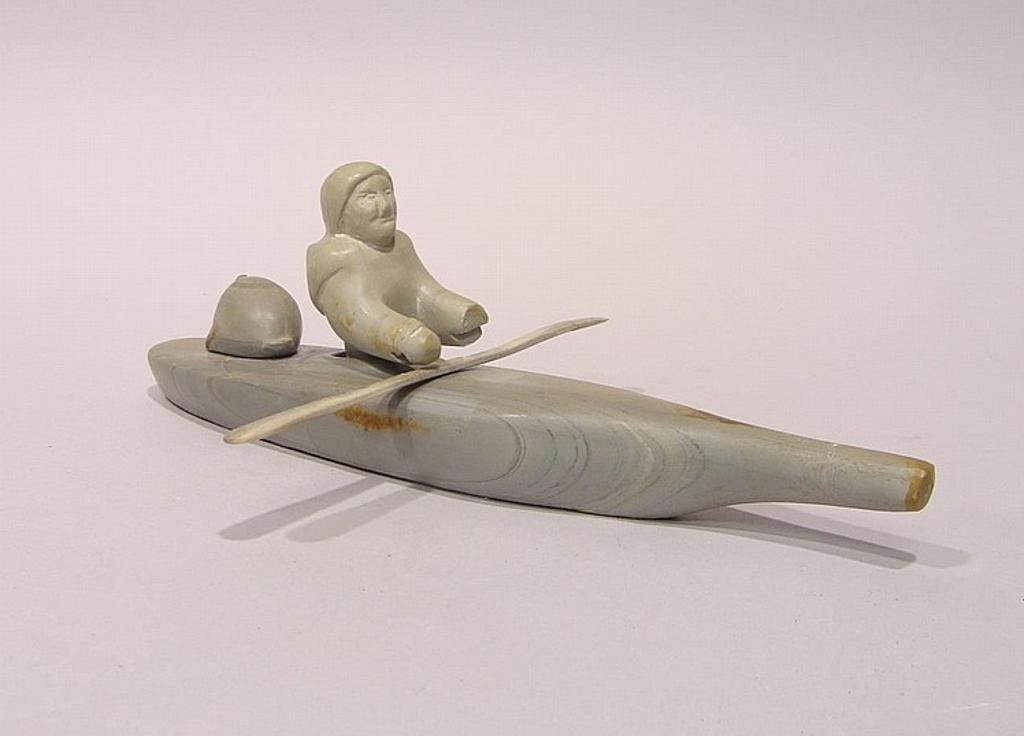 Letia Akumaluk - Arctic Bay a soapstone carving of a figure in a kayak