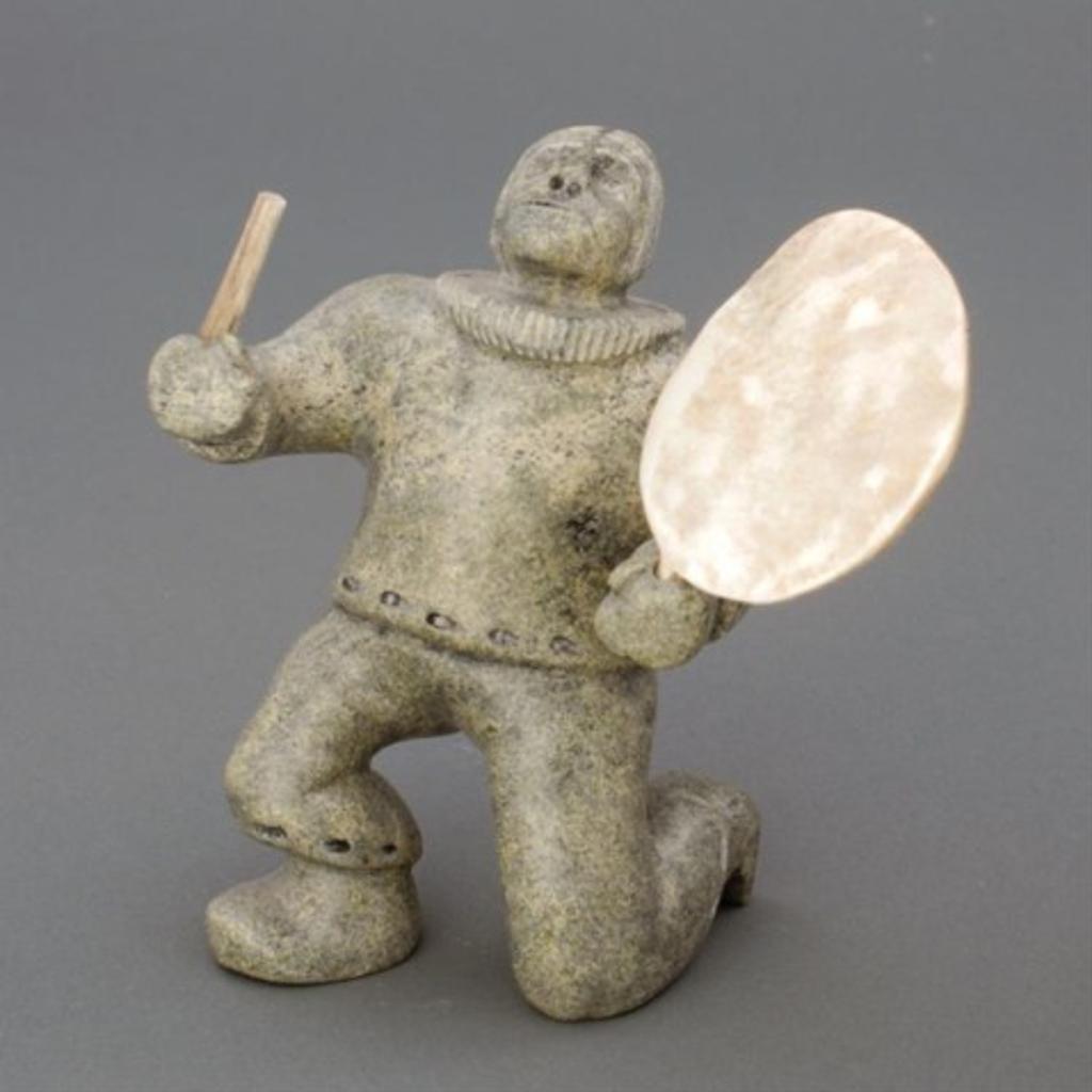 Noah Mark - Light green stone carving of a kneeling Inuit with drum and baton
