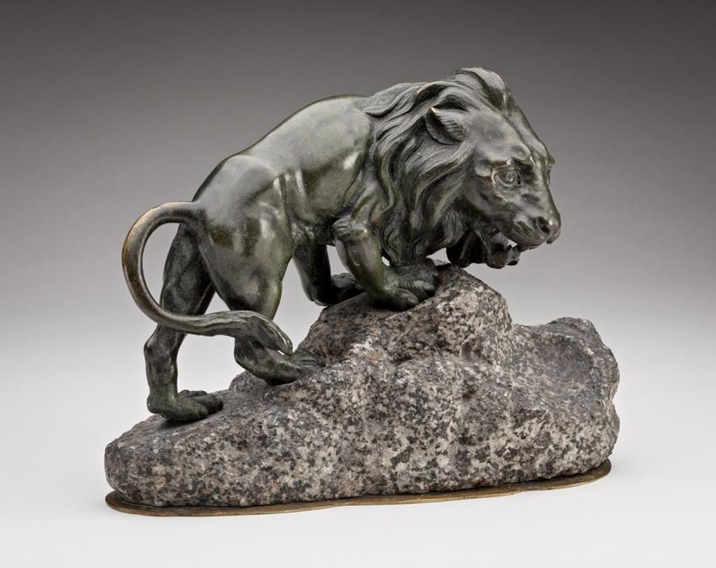 Francois Cogne (1870-1945) - the green/black patinated bronze model of a male lion standing atop a rocky mound