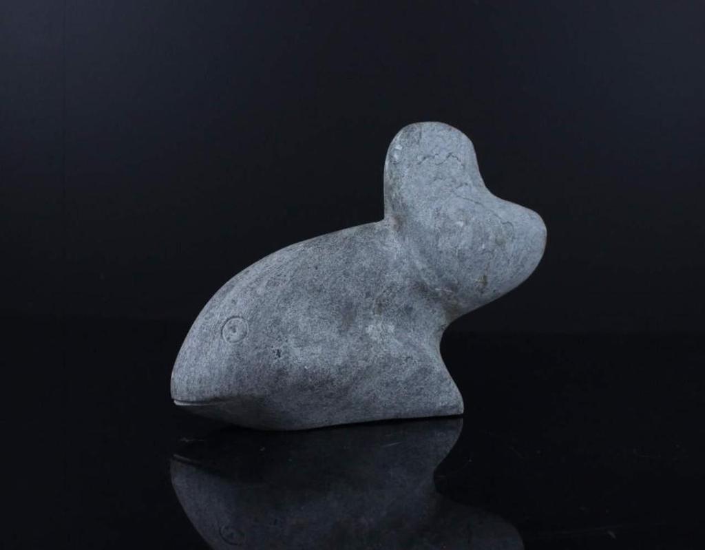 Tuapuk - a grey stone carving of a fish signed in syllabics