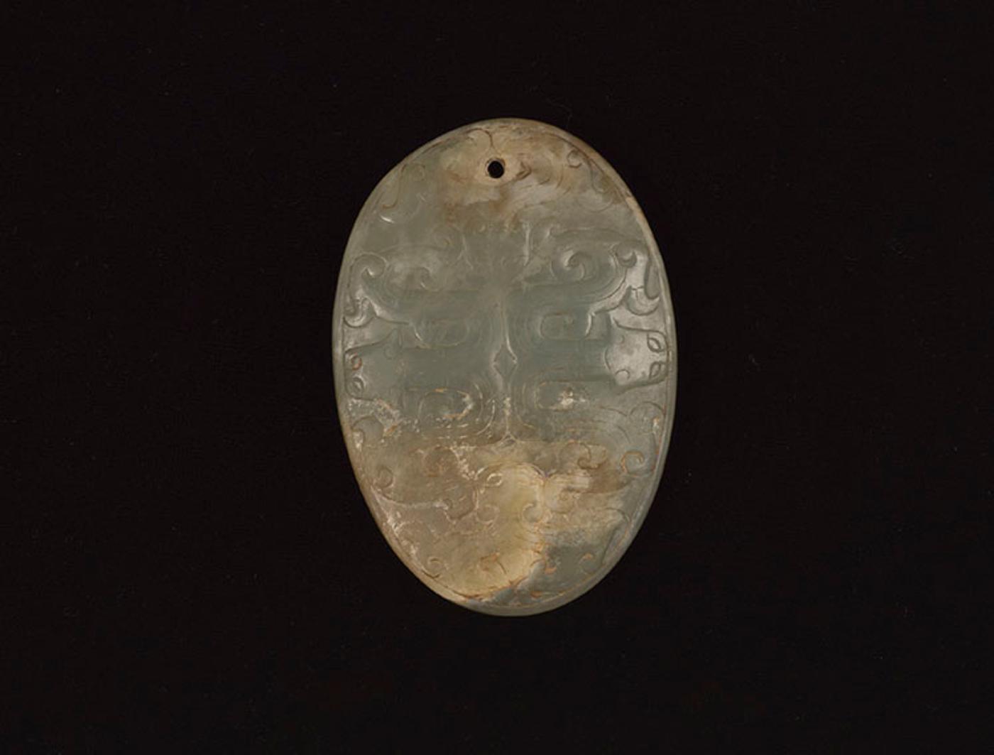 Chinese Art - A Chinese Pale Celadon Jade Oval ‘Dragon’ Pendant