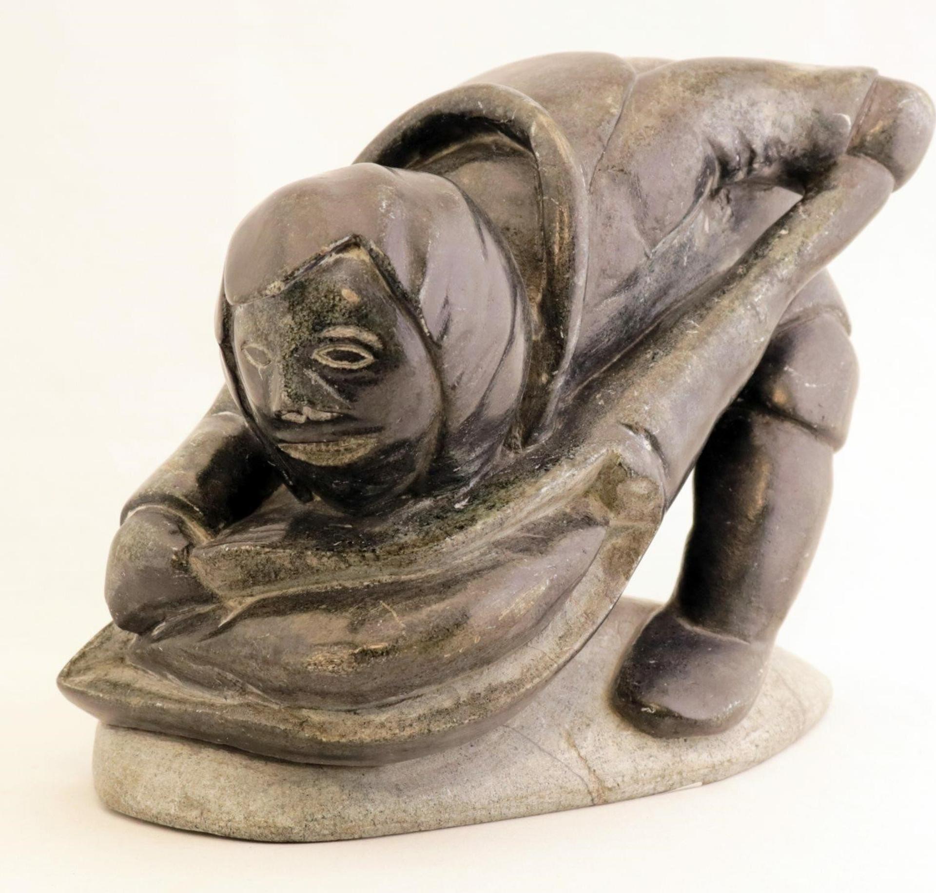 Juanasi Qinuajua Tuluga (1948) - a grey stone carving of a Fisherman